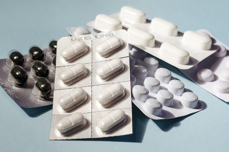 blister of pills. pharmaceutical. disease remedy. over blue background