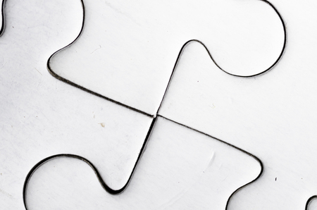 close up of four white jigsaw pieces. teamwork.の写真素材