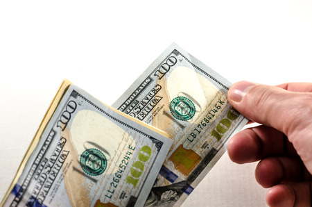 a man is giving away an hundred dollar bills