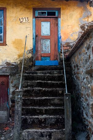 entrance of a traditional house with an old stairway in a rural village in Montesinho Braganca, Portugalの写真素材