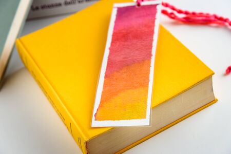 colorful bookmark on a closed yellow book. education. reading.の写真素材
