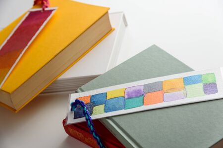 colorful bookmarks on a closed green and yellow books. education. reading.の写真素材