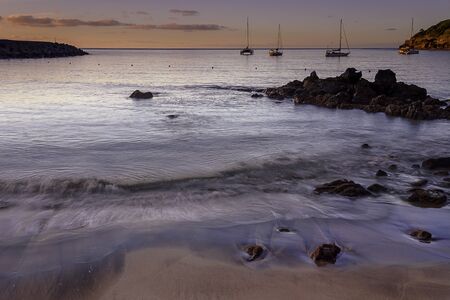 view of the waves crushing over a sandy beach. azores, portugalの写真素材