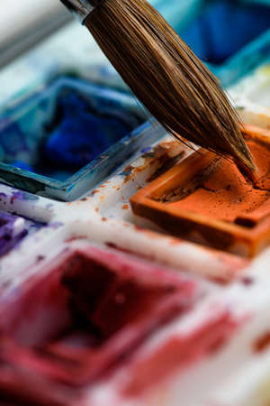 close up of orange watercolor and brush artistic. creative.の写真素材