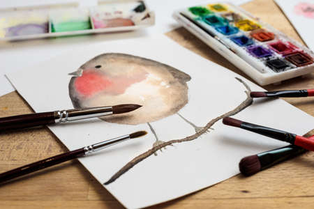 watercolor painting on paper with paint palette and paintbrushesの写真素材