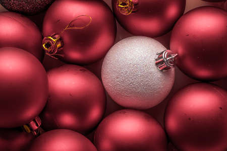 a white Christmas Decoration Balls stands out from a group of red balls. originality. horizontal compositionの写真素材