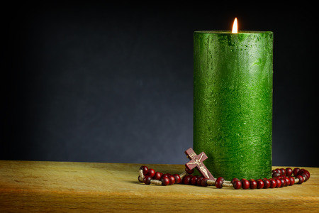 candle with wooden cross