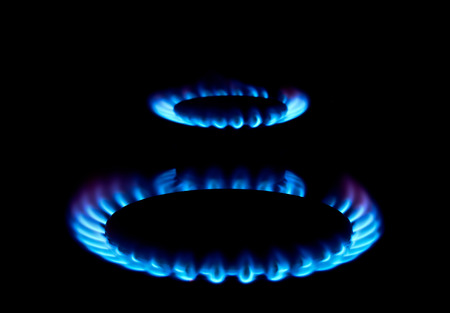 Blue flames of gas stove in the darkの写真素材