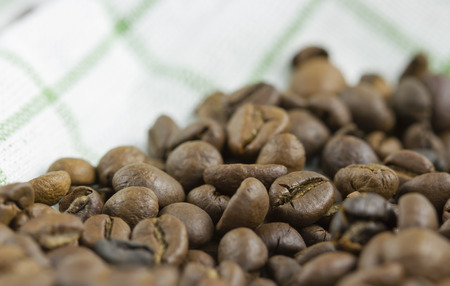 coffee beans on white textileの写真素材