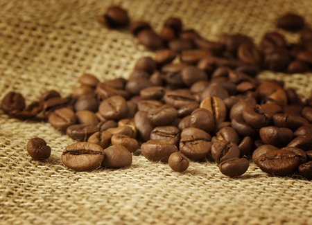 coffee beans over burlapの写真素材