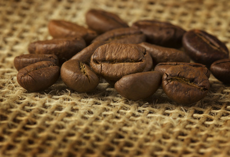coffee beans over burlapの写真素材