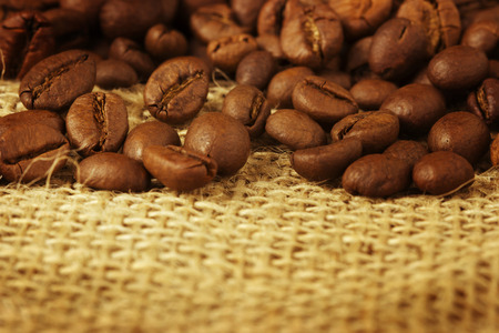 coffee beans over burlapの写真素材