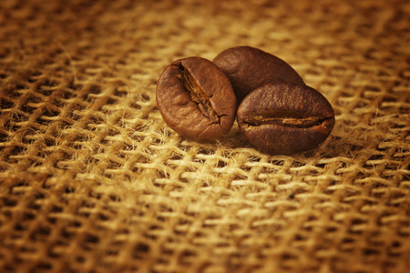 coffee beans over burlapの写真素材