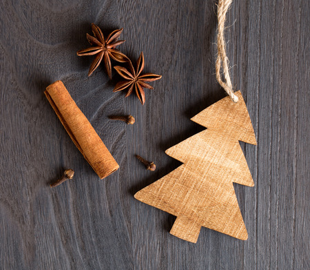 Wooden christmas tree on wooden background and aniseの写真素材