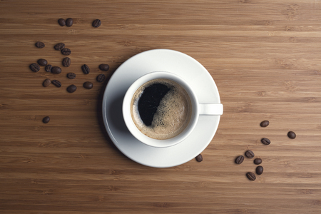 Coffee cup top view on wooden table backgroundの写真素材