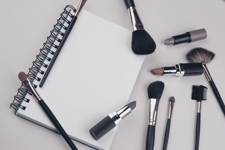 decorative cosmetics with notebook on green backgroundの写真素材