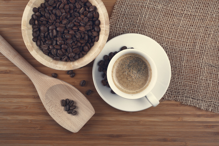 Coffee beans in bowl on wooden backgroundの写真素材