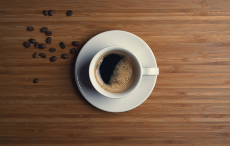 Coffee cup top view on wooden table backgroundの写真素材