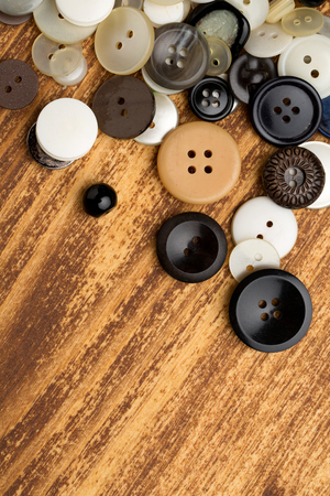 Set of vintage buttons on old wooden tableの写真素材