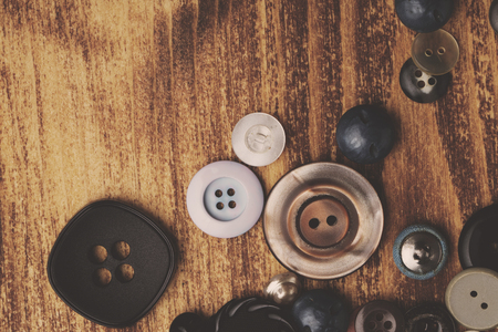 Set of vintage buttons on old wooden tableの写真素材
