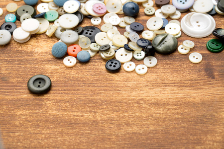 Set of vintage buttons on old wooden tableの写真素材