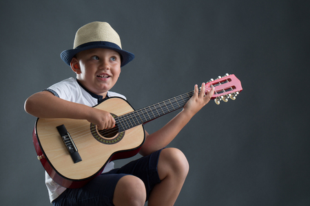 Little boy is playing the guitarの写真素材