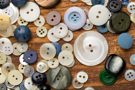 Set of vintage buttons on old wooden tableの写真素材