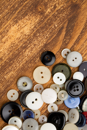 Set of vintage buttons on old wooden tableの写真素材