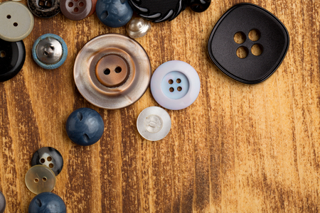 Set of vintage buttons on old wooden tableの写真素材