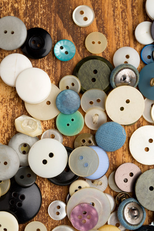 Set of vintage buttons on old wooden tableの写真素材