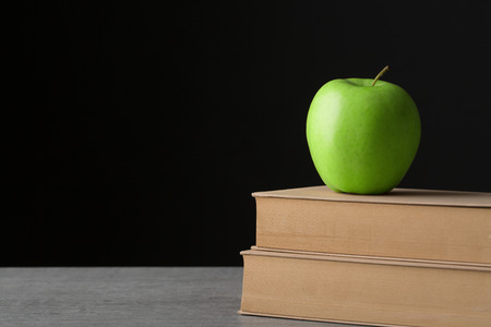 Green apple on old bookの写真素材