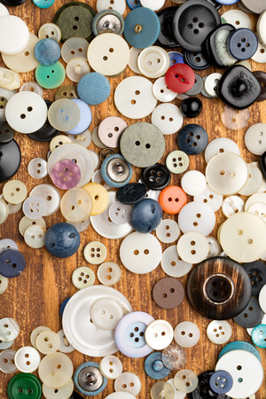 Set of vintage buttons on old wooden tableの写真素材