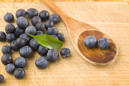 wooden spon with blueberriesの写真素材