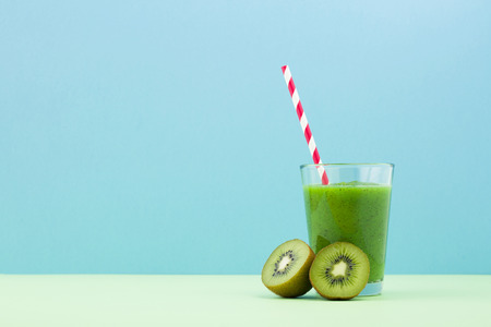 Fresh kiwi smoothie over blue backgroundの写真素材