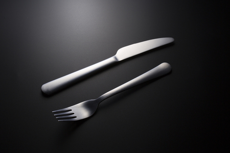 cutlery over black backgroundの写真素材