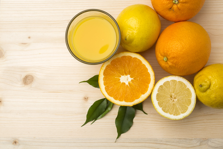 Fresh citrus fruits on a old wooden tableの写真素材