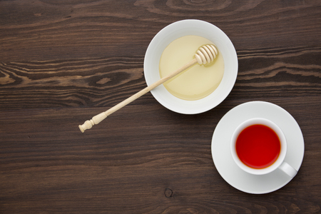 Tea with  honey on the wooden background.の写真素材