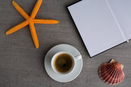 Blank closed booklet and coffee cupの写真素材