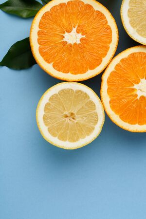 Oranges and lemon with orange juice on blue backgroundの写真素材