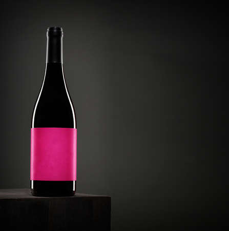 Red wine bottle on dark backgroundの写真素材