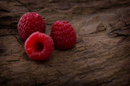 Fresh raspberry in a wooden plateの写真素材