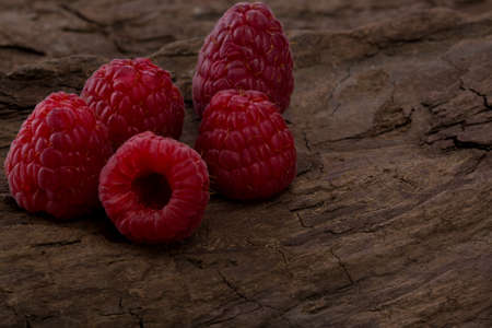 Fresh raspberry in a wooden plateの写真素材