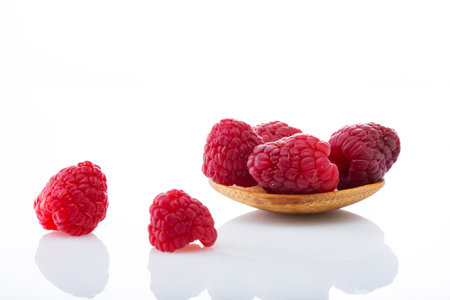 sweet raspberries isolated on a white backgroundの写真素材
