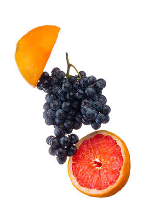 Dark blue grape with red grapefruit isolated on white backgroundの写真素材
