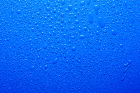 Water drops on a blue color surfaceの写真素材