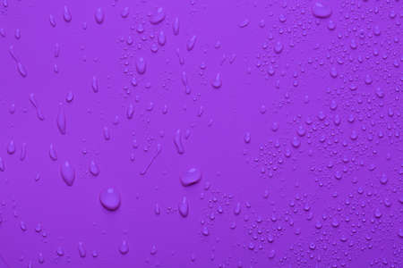 Water drops on a purple color surfaceの写真素材
