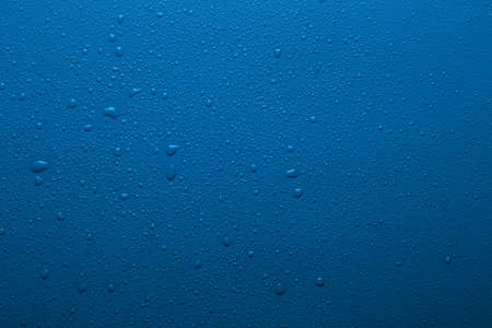 Water drops on a blue color surfaceの写真素材