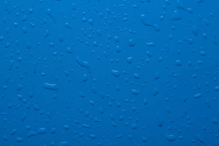 Water drops on a blue color surfaceの写真素材