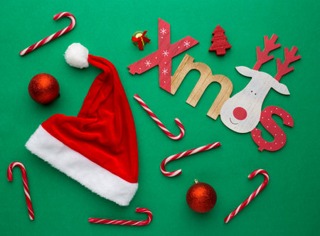 Christmas background with decoration candies and santa s hatの写真素材