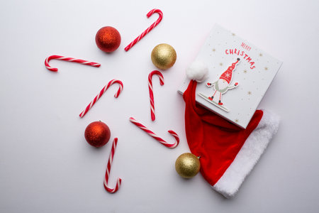 Christmas background with decoration candies and Santa's hatの写真素材